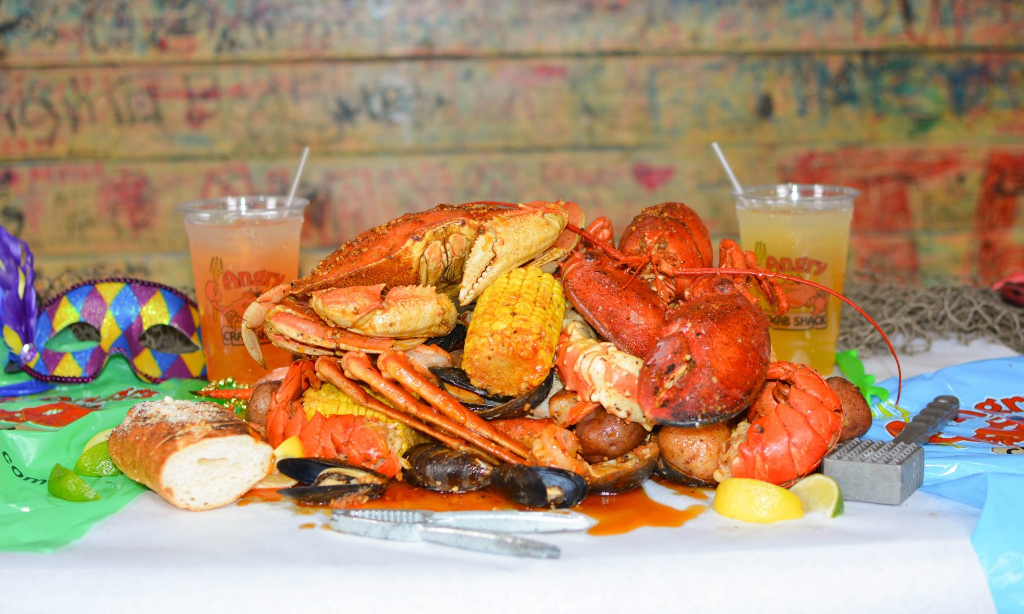 Cooked Snow Crab, Lobster, Corn, Potatoes, and Mussels laid on the Angry Crab Table Seasoned to perfection and ready to be devoured!