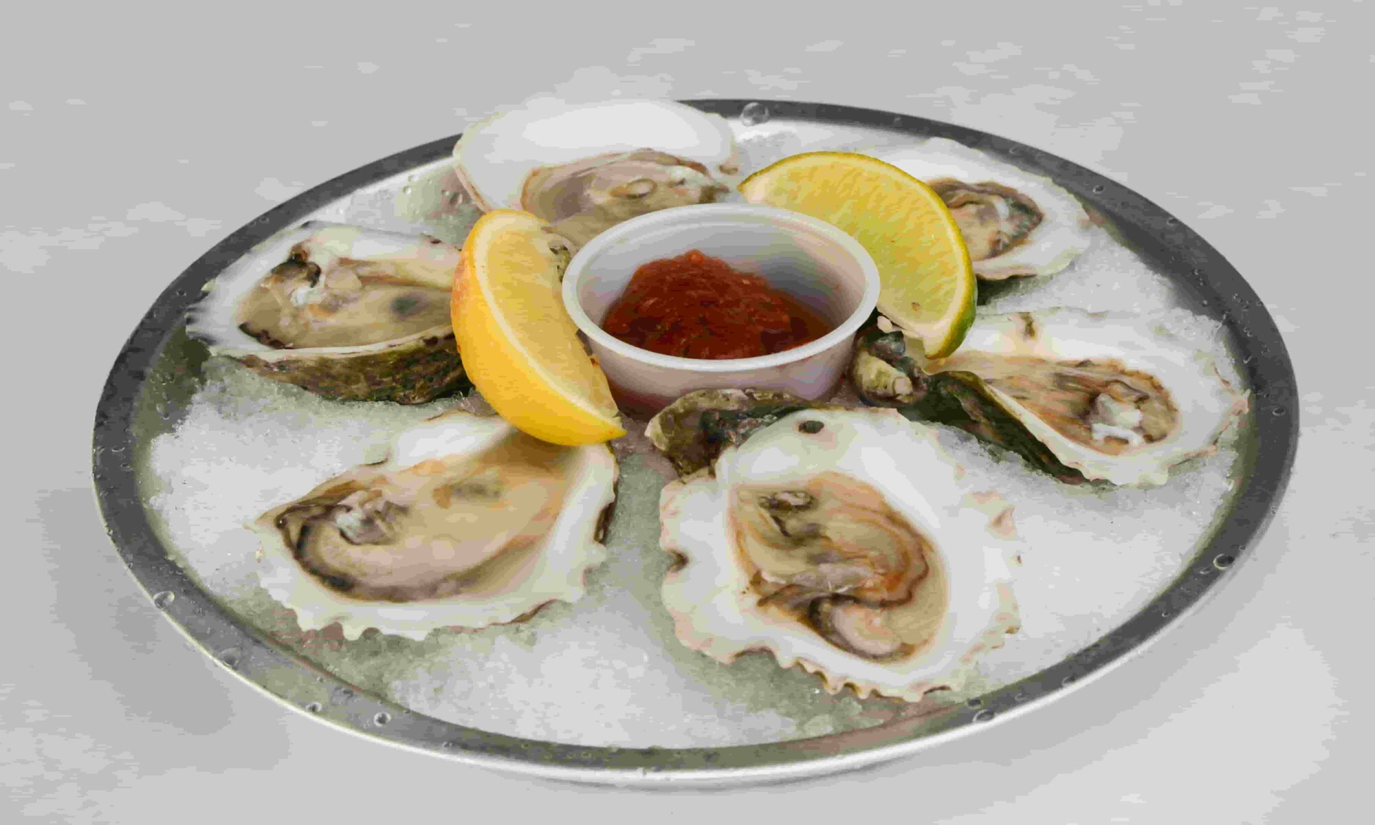 Oysters on ice served with Lemon and sauce
